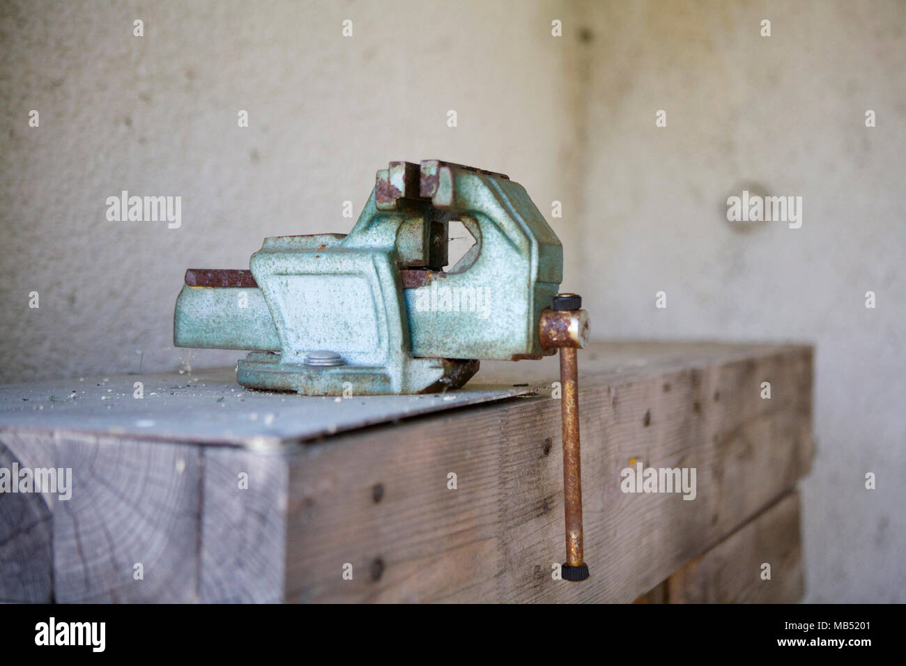 Vise clamp on wooden working table Stock Photo