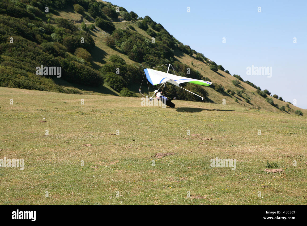 Hang glider landing Stock Photo