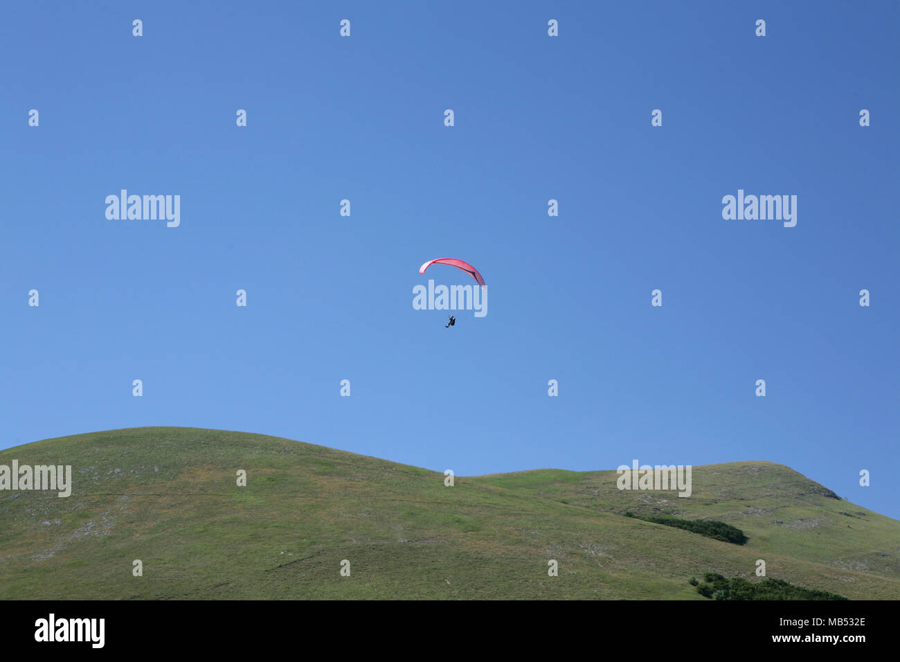 Hang glider over the mountain Stock Photo