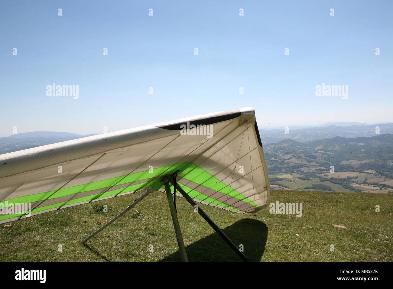 White hang glider parked on the mountain Stock Photo