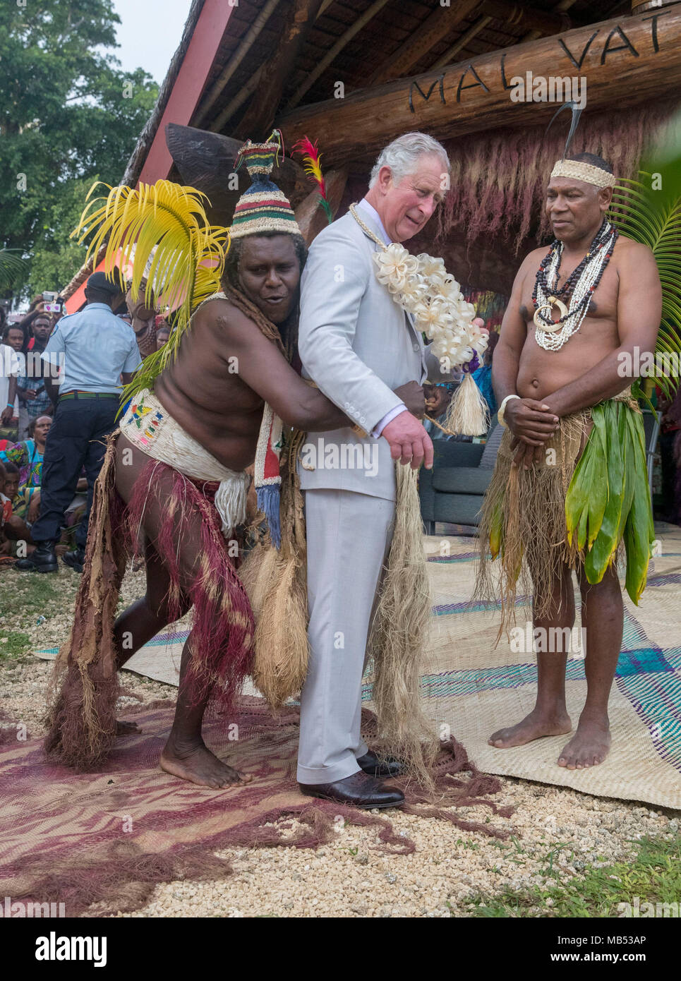 The Prince of Wales is given a grass skirt to wear prior to receiving a chiefly title during a visit to the Chiefs' Nakamal, as he visits the South Pacific island of Vanuatu during his tour of the region. Stock Photo