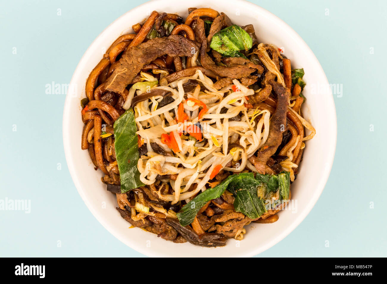 Chinese Style Wok Fried Shanghai Beef Noodles Against A Blue Background