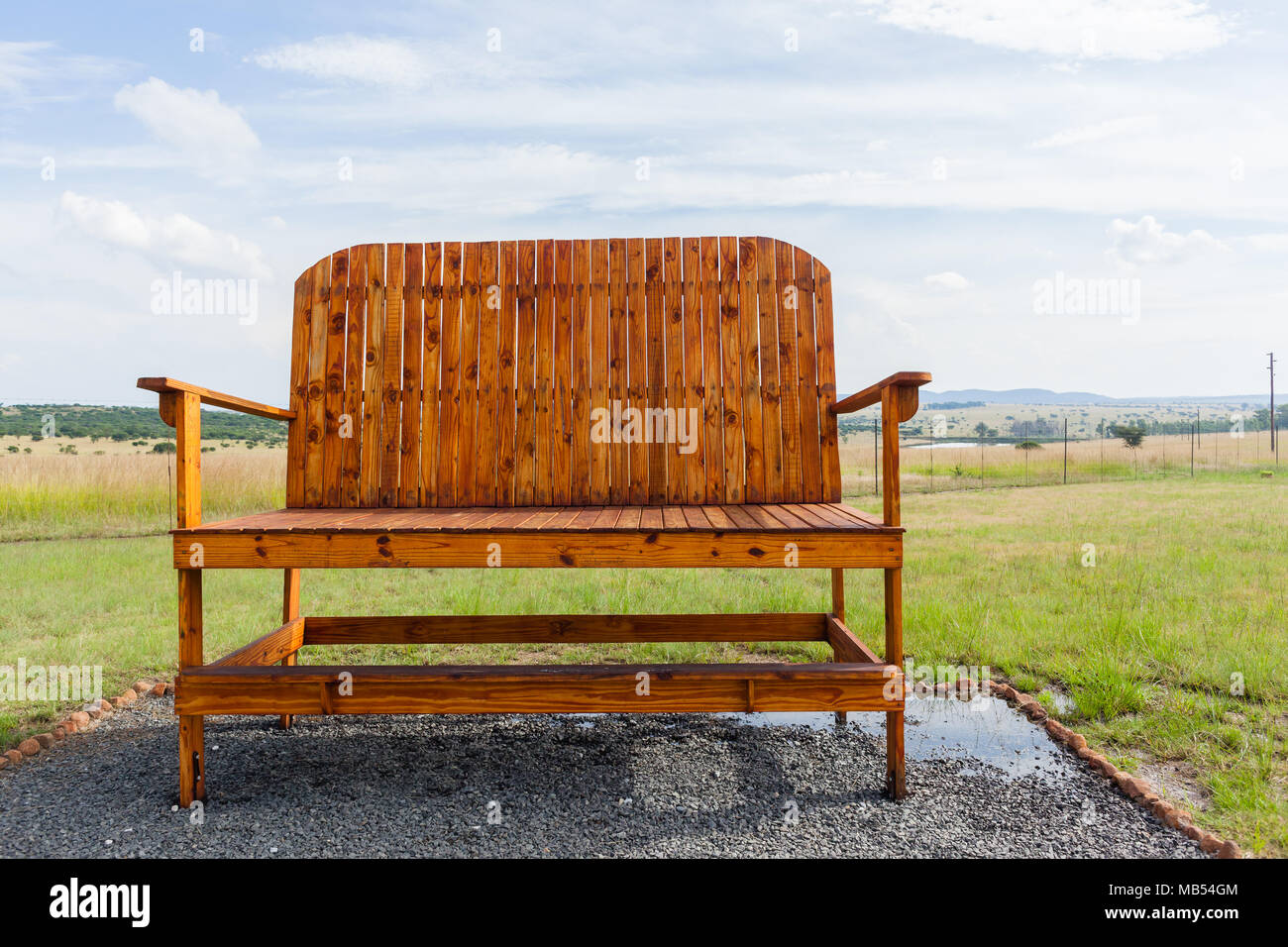 Big large wood chair bench placed outdoors roadside trading store countryside rural farmlands landscape Stock Photo Alamy
