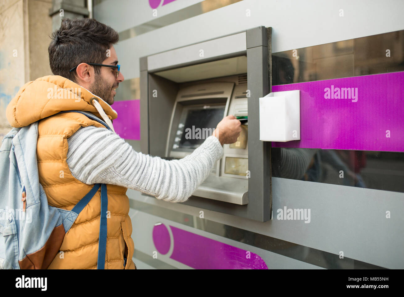 The tourist withdraws money from the ATM for further travel. Finance, credit card, withdrawal of money. Life style. Journey. Vacation. Stock Photo