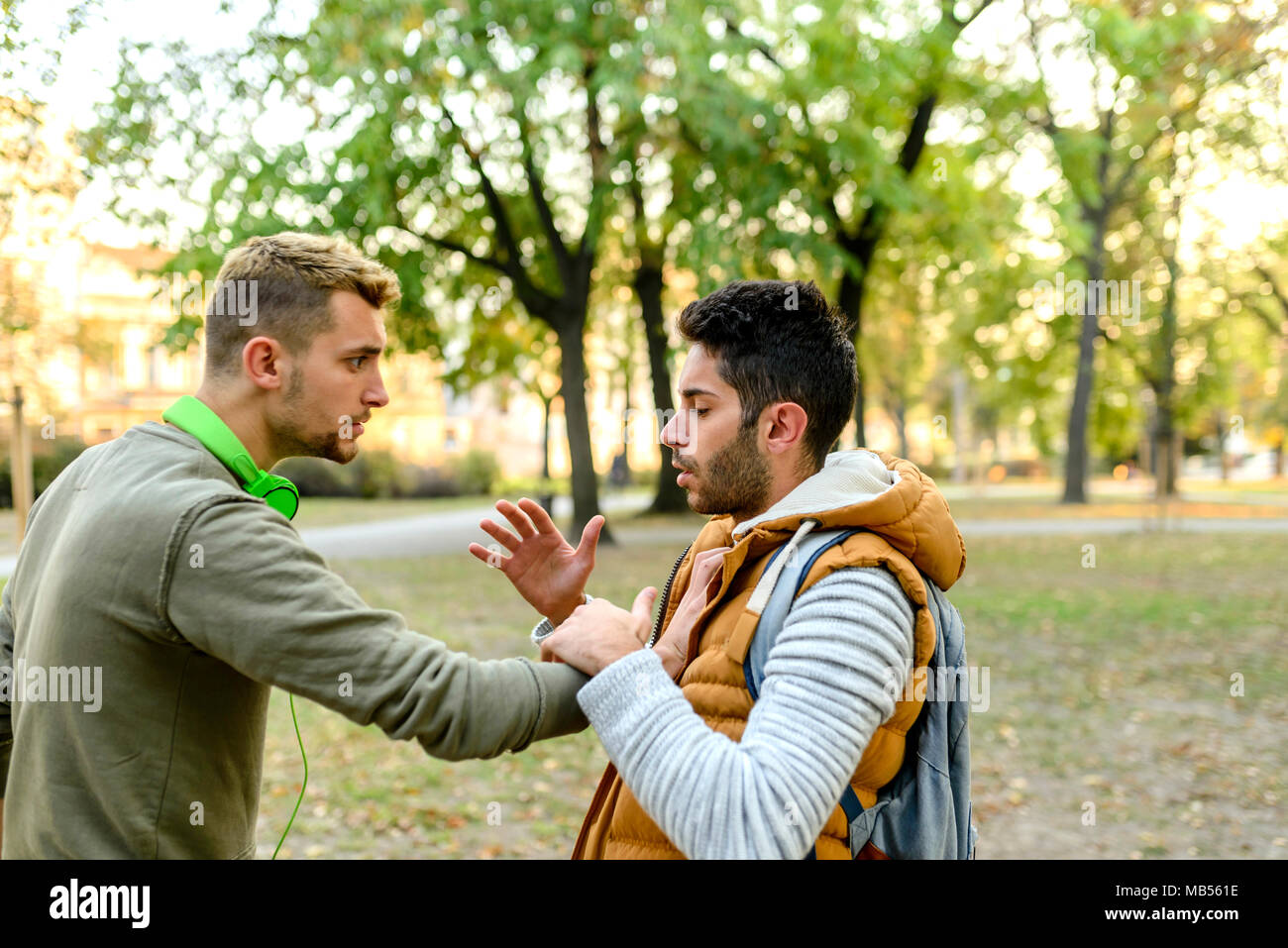 Two friends having a debate in the public park Stock Photo