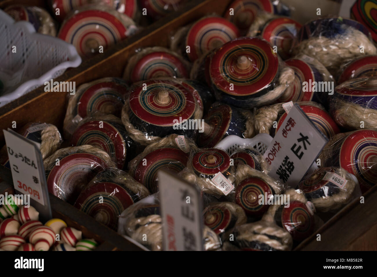 In Japan, spinning tops are believed to bring good luck and prosperity. Using abundant timber Oyama craftsmen have been turning them since Edo period. Stock Photo