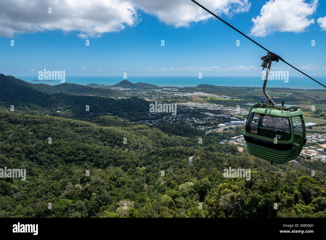 A gondola on the Skyrail Rainforest Cableway with Cairns and the Pacific Ocean in the background Stock Photo