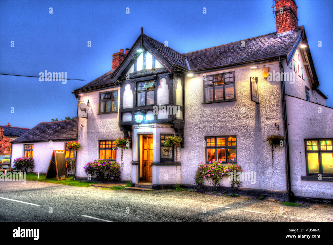 Village of Shocklach, Cheshire, England. Artistic evening view of the Bull Inn public house. Stock Photo