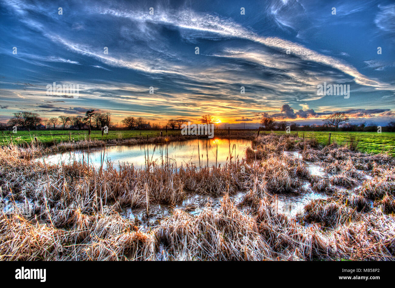 Village of Coddington, England. Artistic sunset view of a freshwater