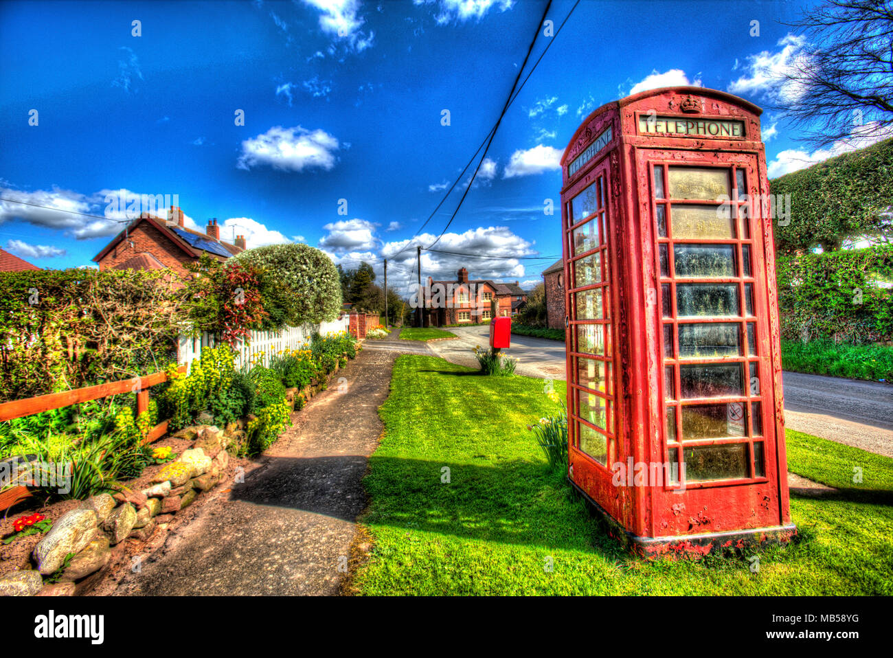 Village of Barton, England. Artistic view of the picturesque Cheshire village of Barton, with an unused K6 red telephone box in the foreground. Stock Photo