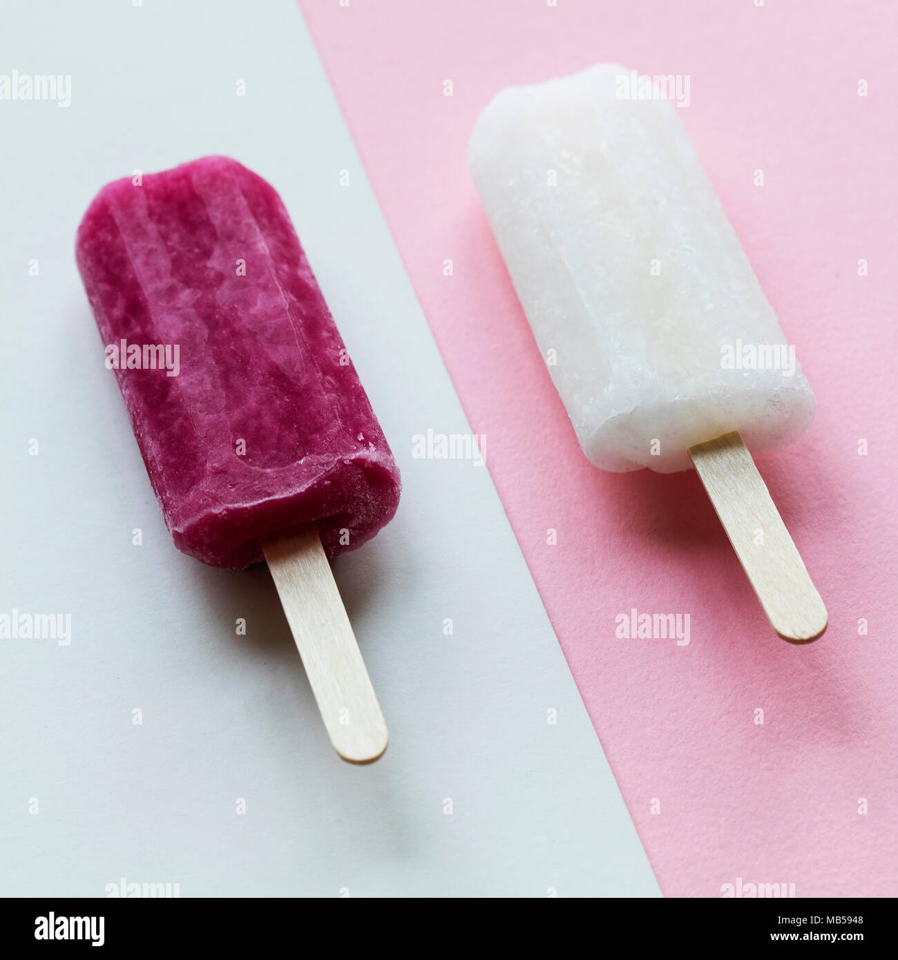 pink and white summer ice lollies on a pink background Stock Photo Alamy