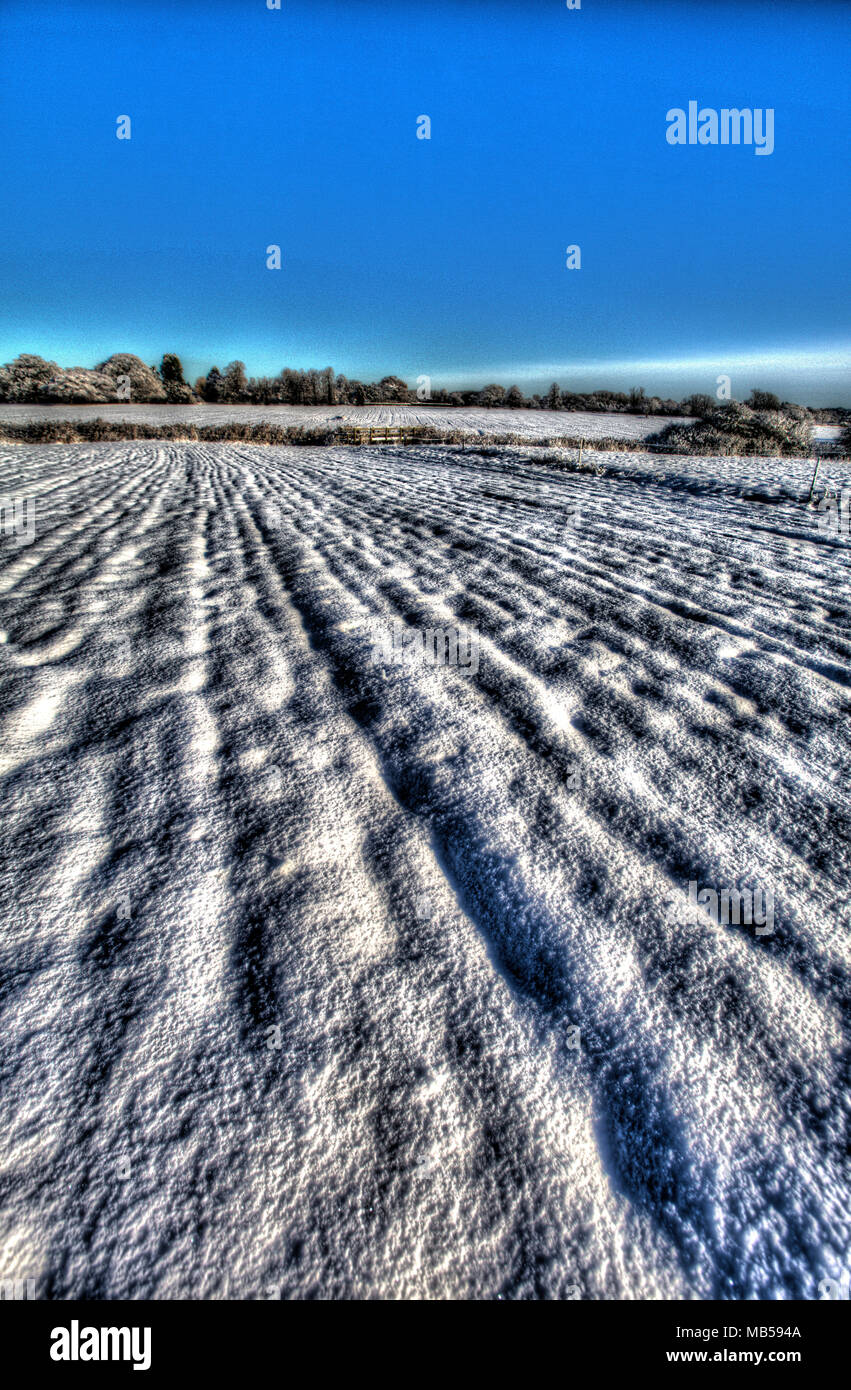 Village of Coddington, England. Artistic view of a snow covered field in rural Cheshire. Stock Photo