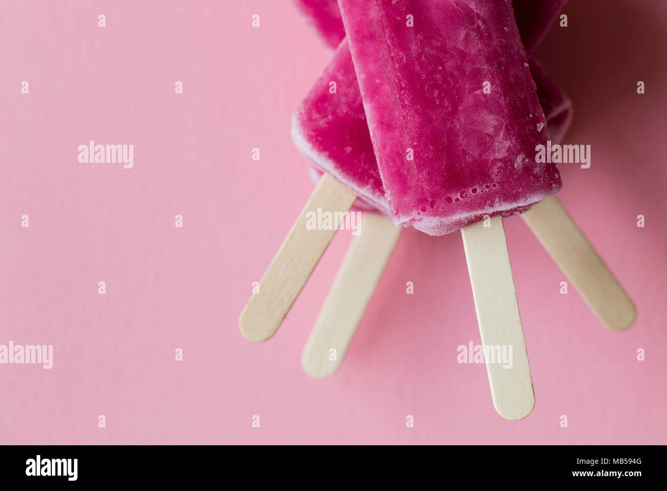 Pink Raspberry Lollies Raspberry flavour summertime ice lollies on a pink background Stock ...