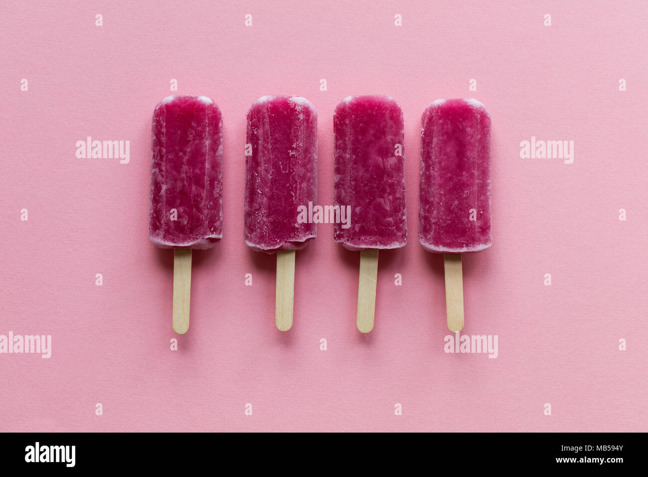 Pink Raspberry Lollies Raspberry flavour summertime ice lollies on a pink background Stock ...
