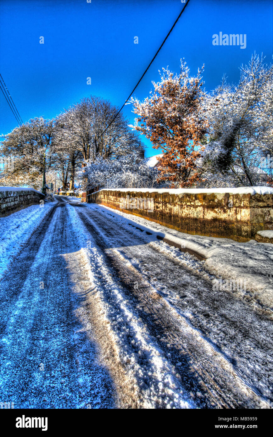 Village of Coddington, England. Artistic winter view of a rural non-gritted road, in rural Cheshire. Stock Photo