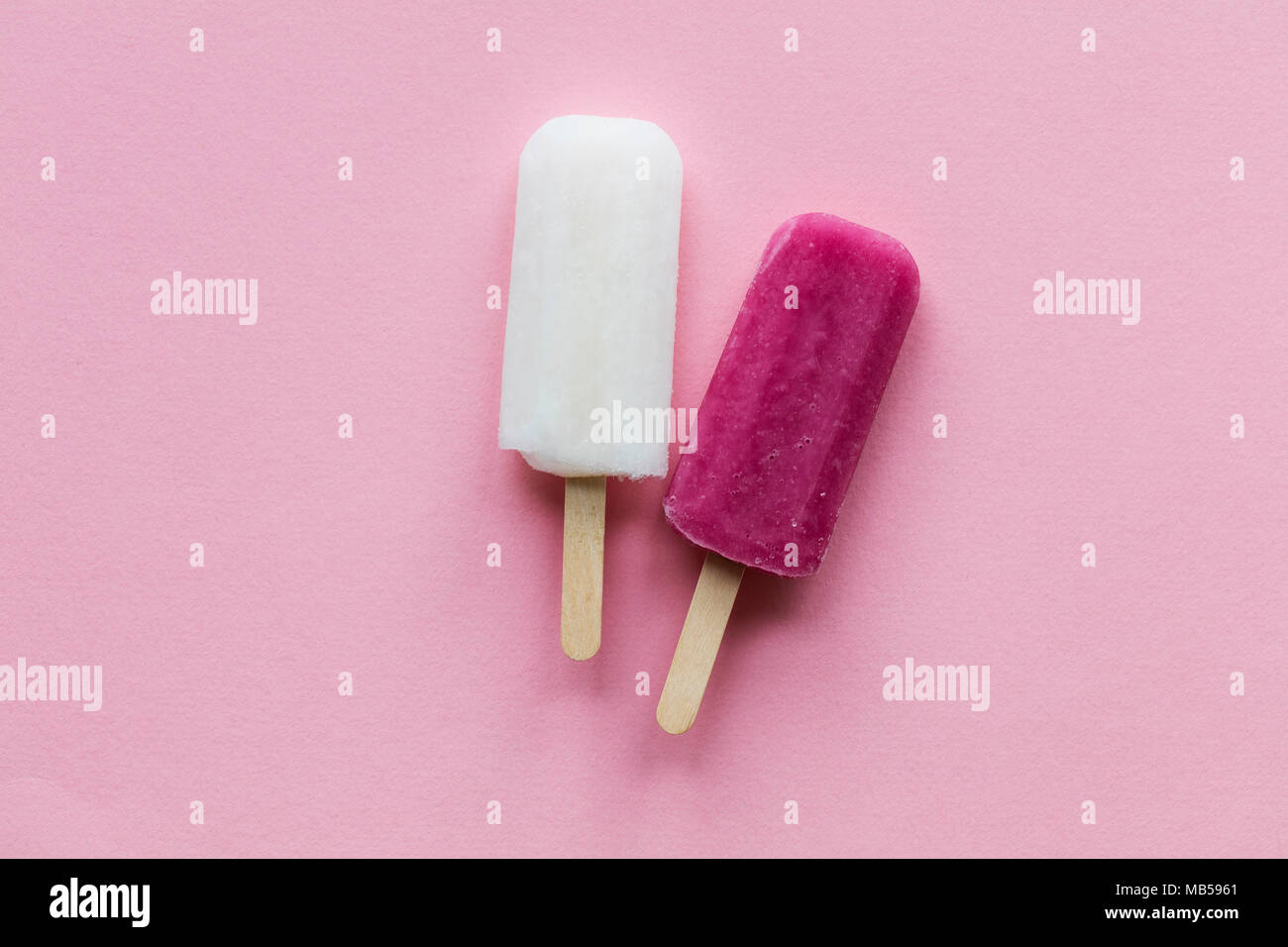 pink and white summer ice lollies on a pink background Stock Photo Alamy
