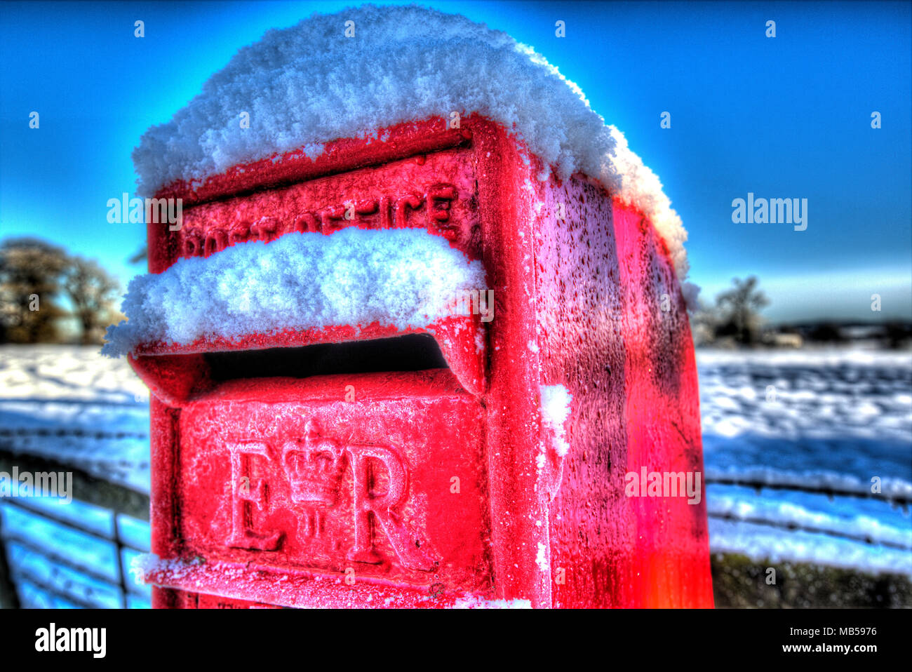 Village of Coddington, England. Artistic winter view of a red Post Office letter collection box, in the Cheshire village of Coddington. Stock Photo