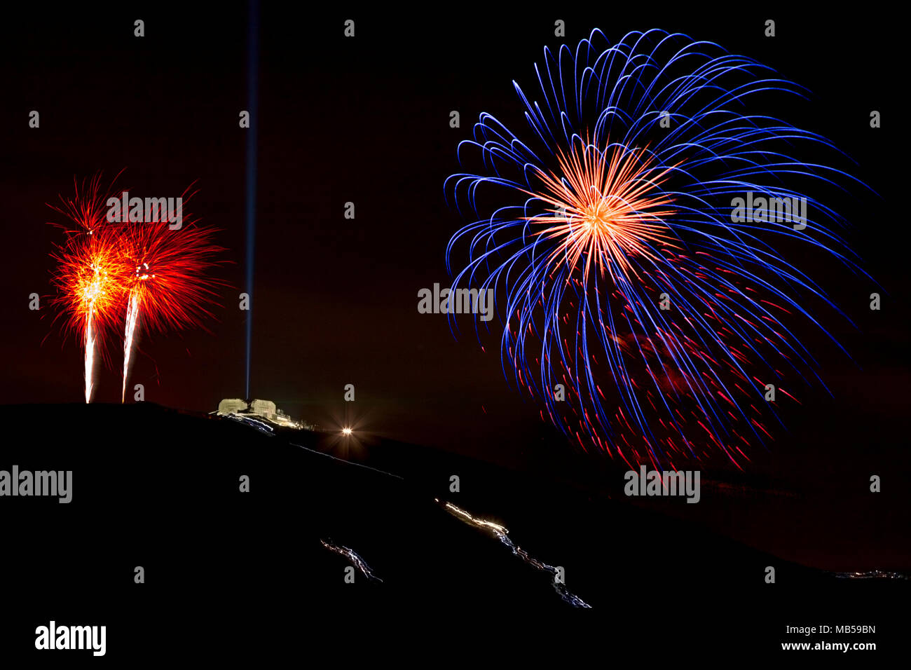 Fireworks over the Jubilee Tower on the summit of Moel Famau at night Stock Photo
