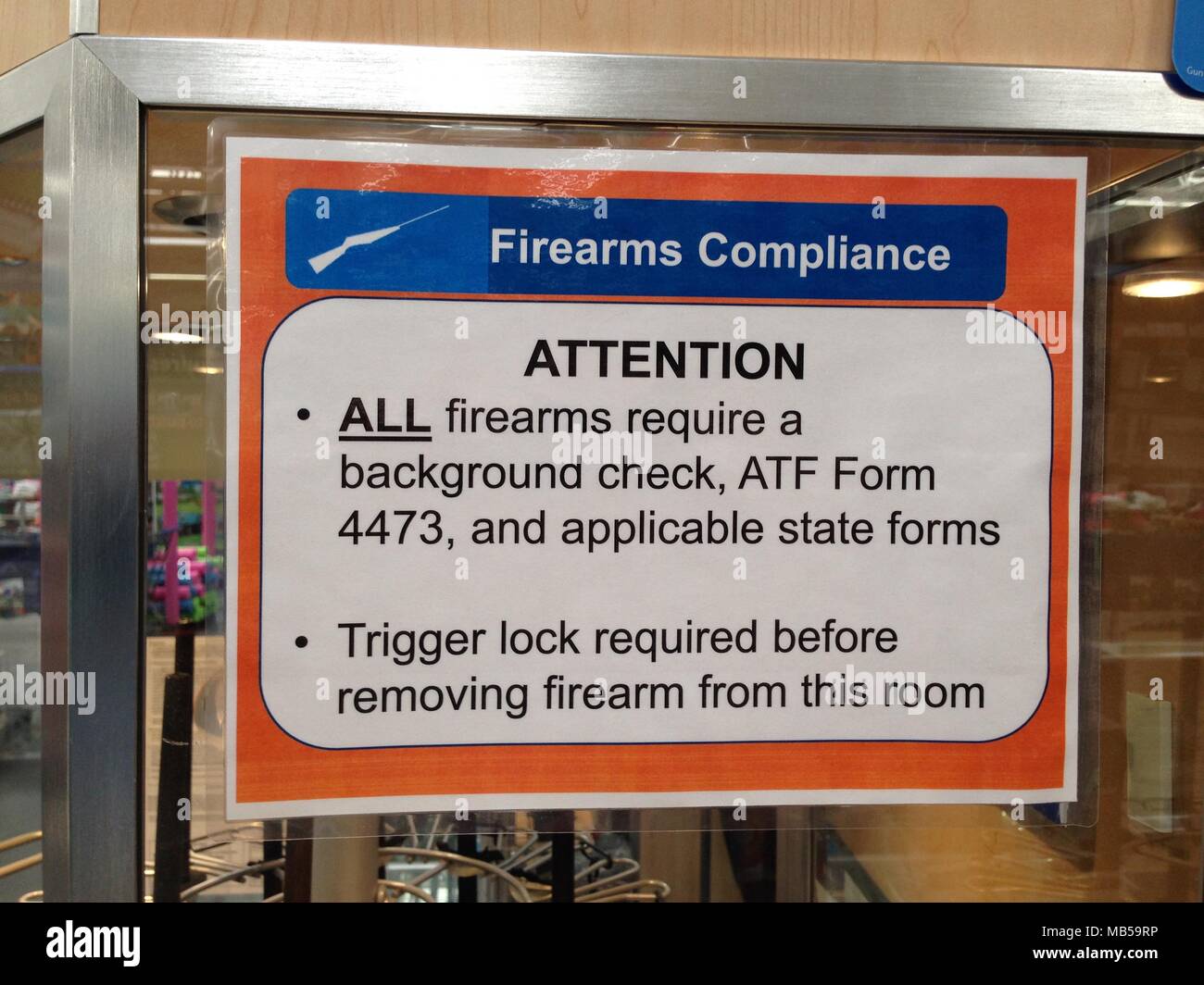 A Walmart Supercenter posts a sign announcing their new firearm and ammunition sales policy.  In order to purchase a firearm or ammunition you must no Stock Photo