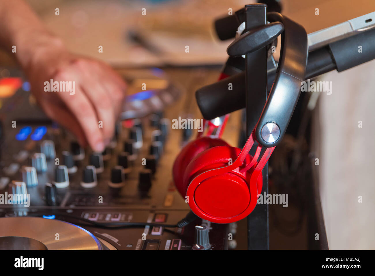 Dj mixer with headphones at . Dj mixes the track in the