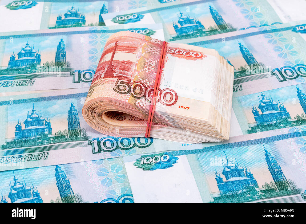 Folded five thousandths banknotes of russian roubles over banknotes background Stock Photo - Alamy