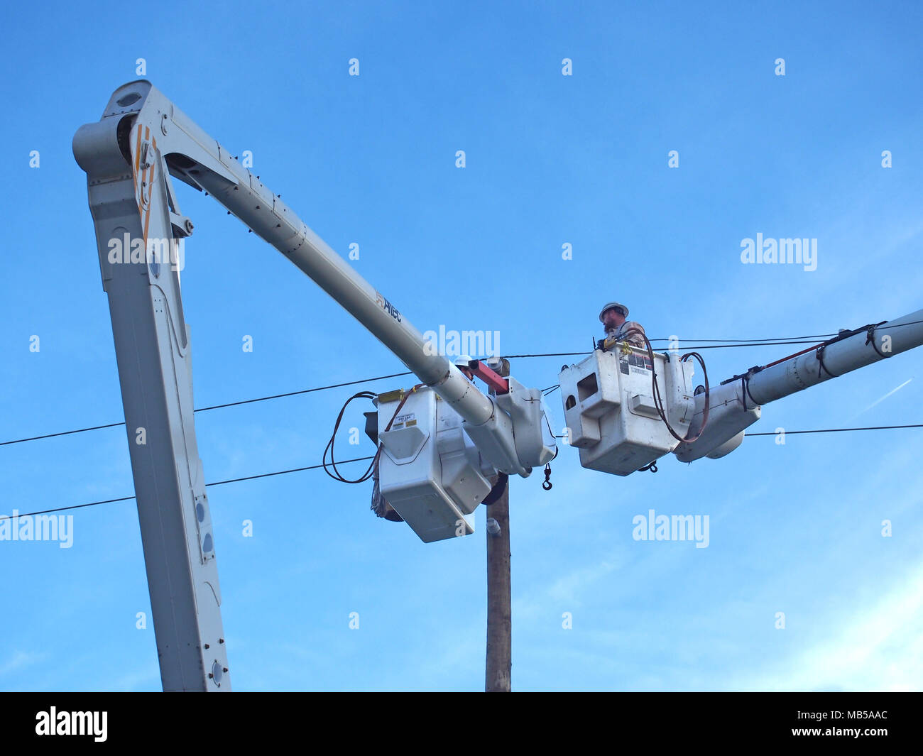 Emergency workers repairing damaged electrical wire which caused a