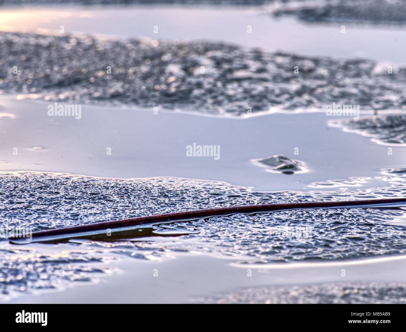 Natural winter icy background of defocused ice with copy space. Blue