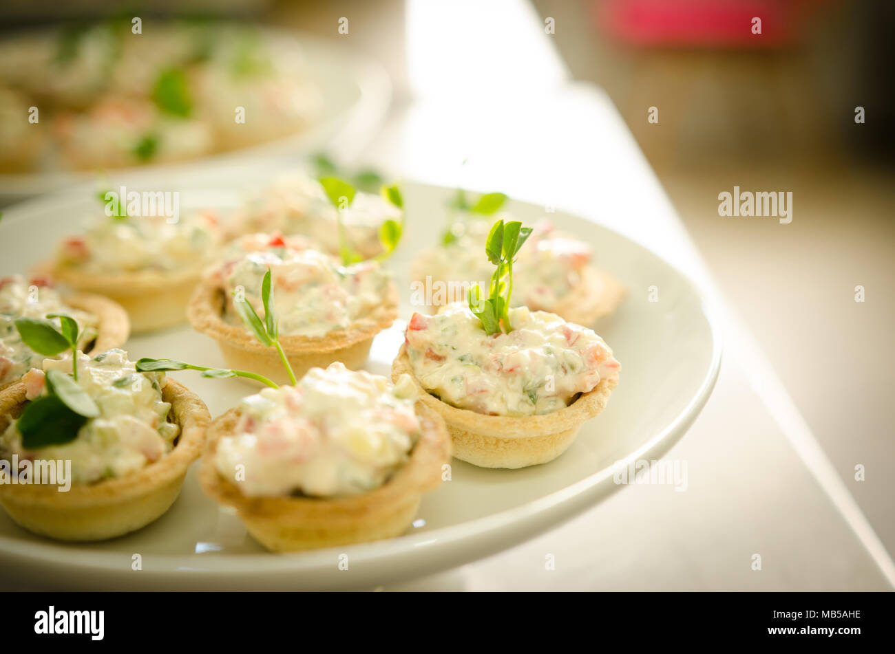 Close up view. Catering buffet table with a delicious food. Tartlets with cream cheese salad Stock Photo