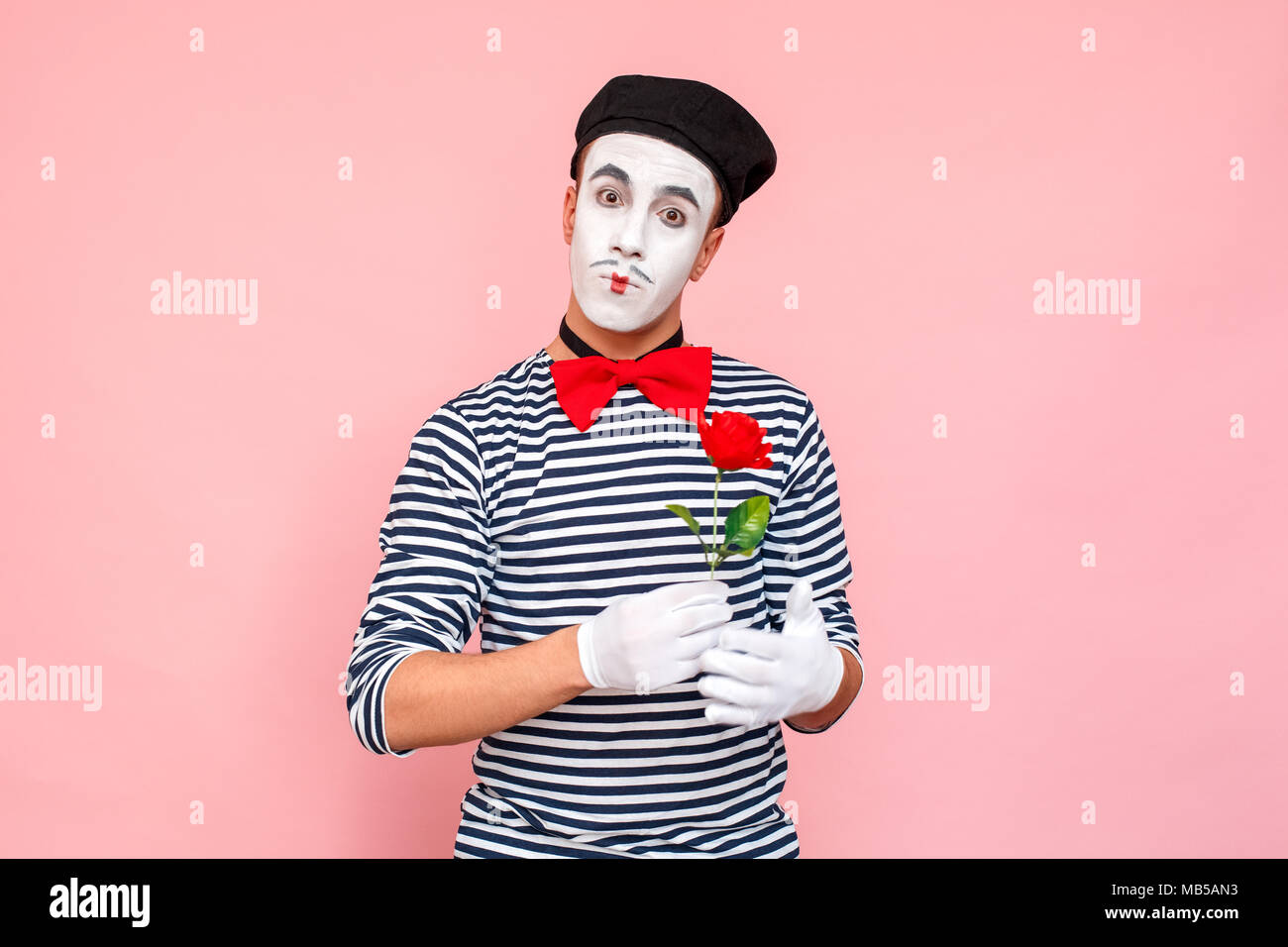 Portrait of romantic man present red rose for you. Clown, artist ...