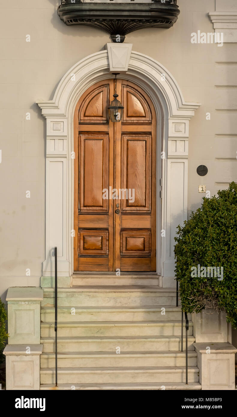 Arching Wooden Door on Old House in historic district Stock Photo