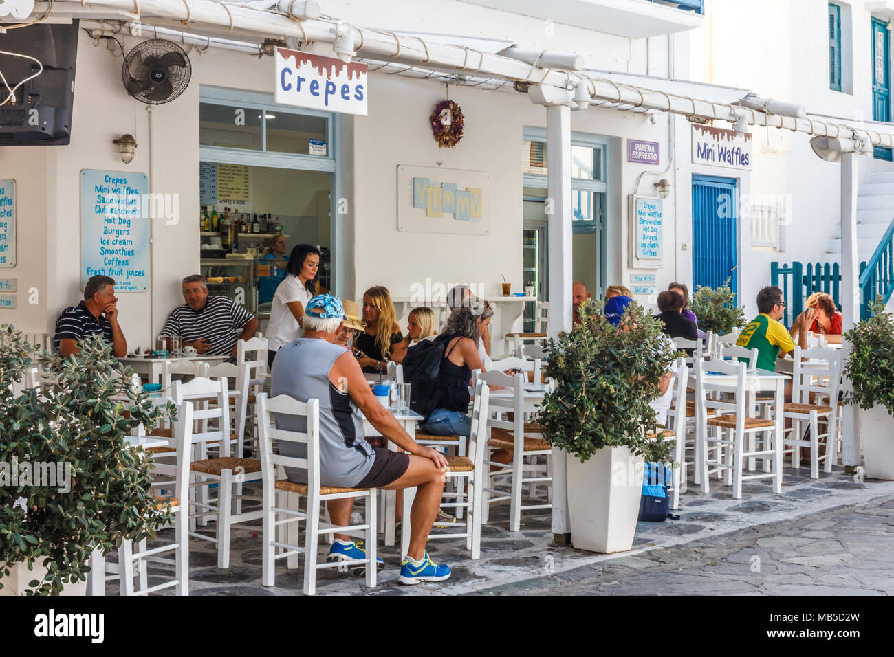 Tourists sat in cafe, Mykonos, Greece Stock Photo