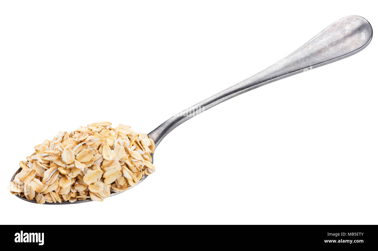 Oat flakes in spoon isolated on white background Stock Photo