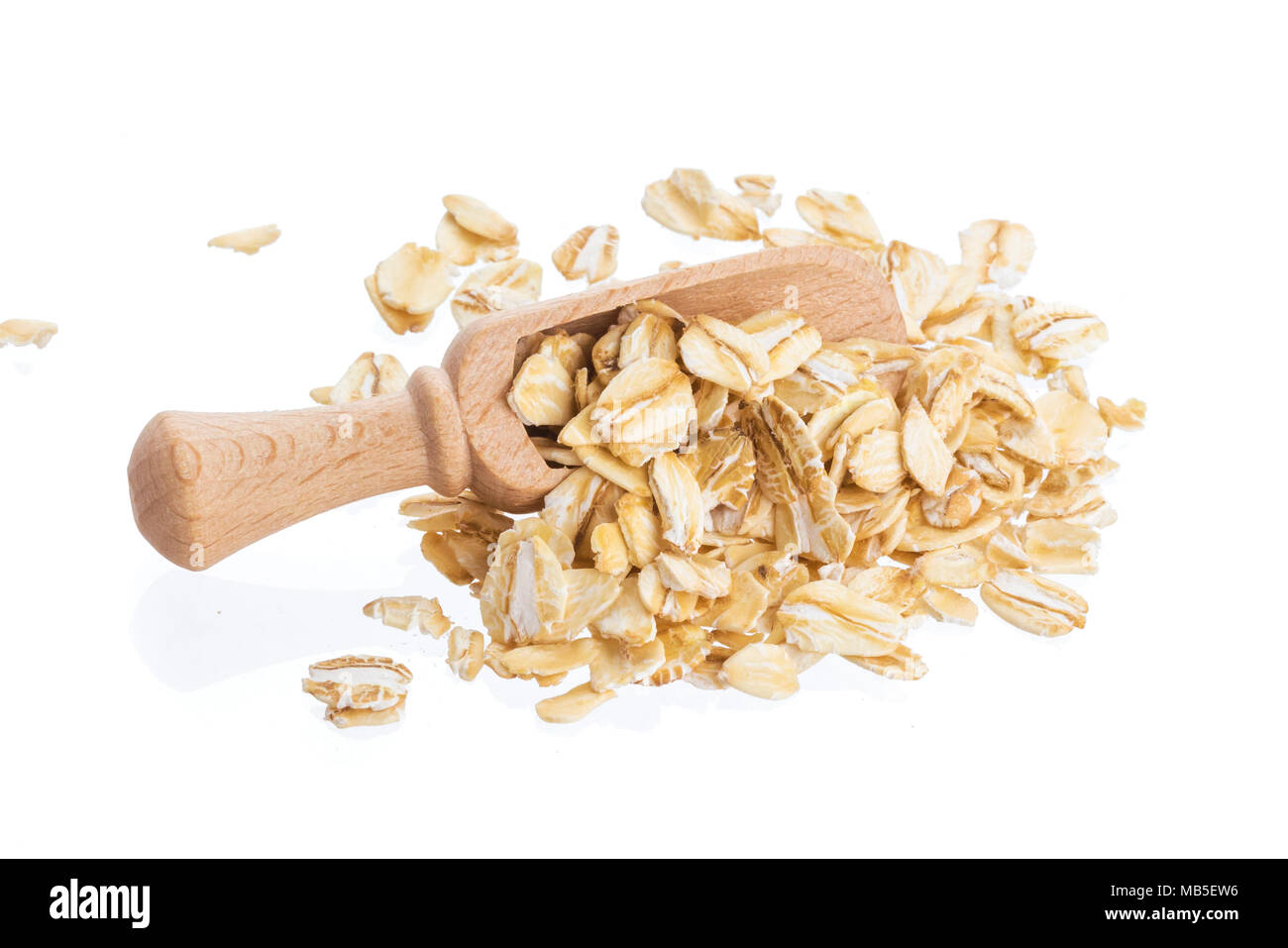 Oat flakes in wooden scoop isolated on white background. Close up. Stock Photo