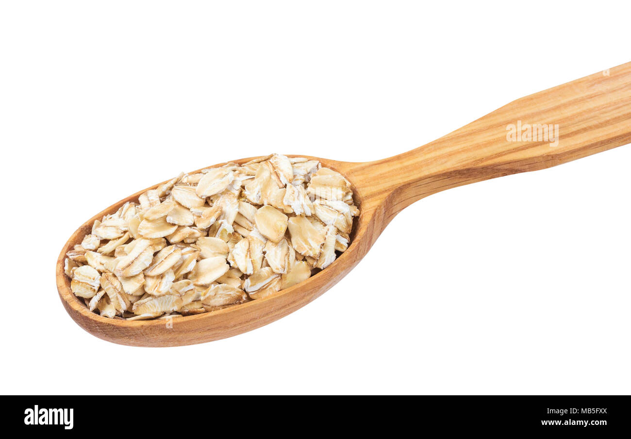 Oatmeal. Oat flakes in wooden spoon isolated on white background Stock Photo