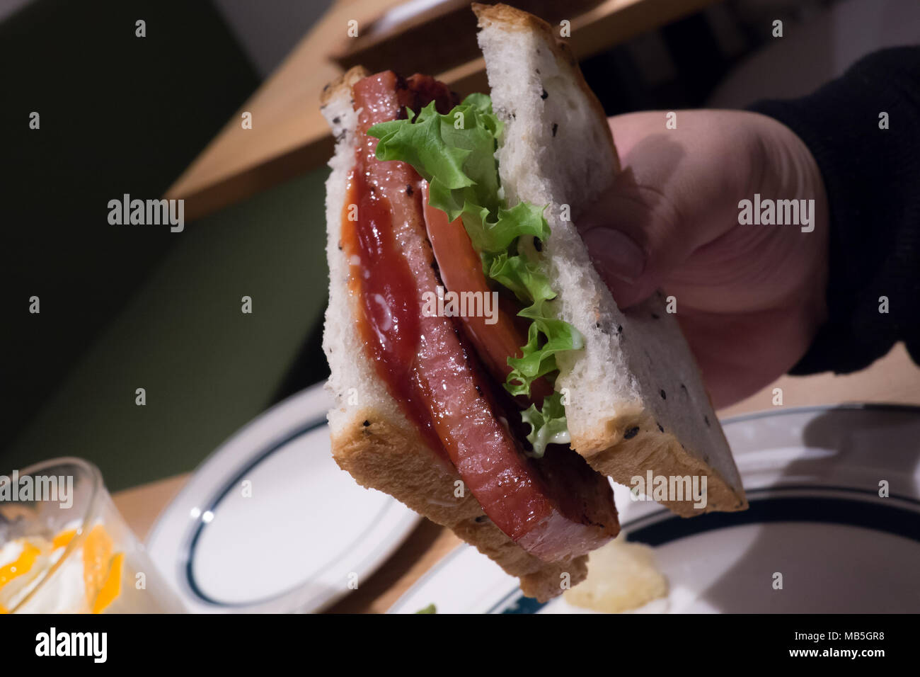 BLT sandwich with a thick slice of bacon, tomato, lettuce, tomato sauce and mayonnaise Stock Photo
