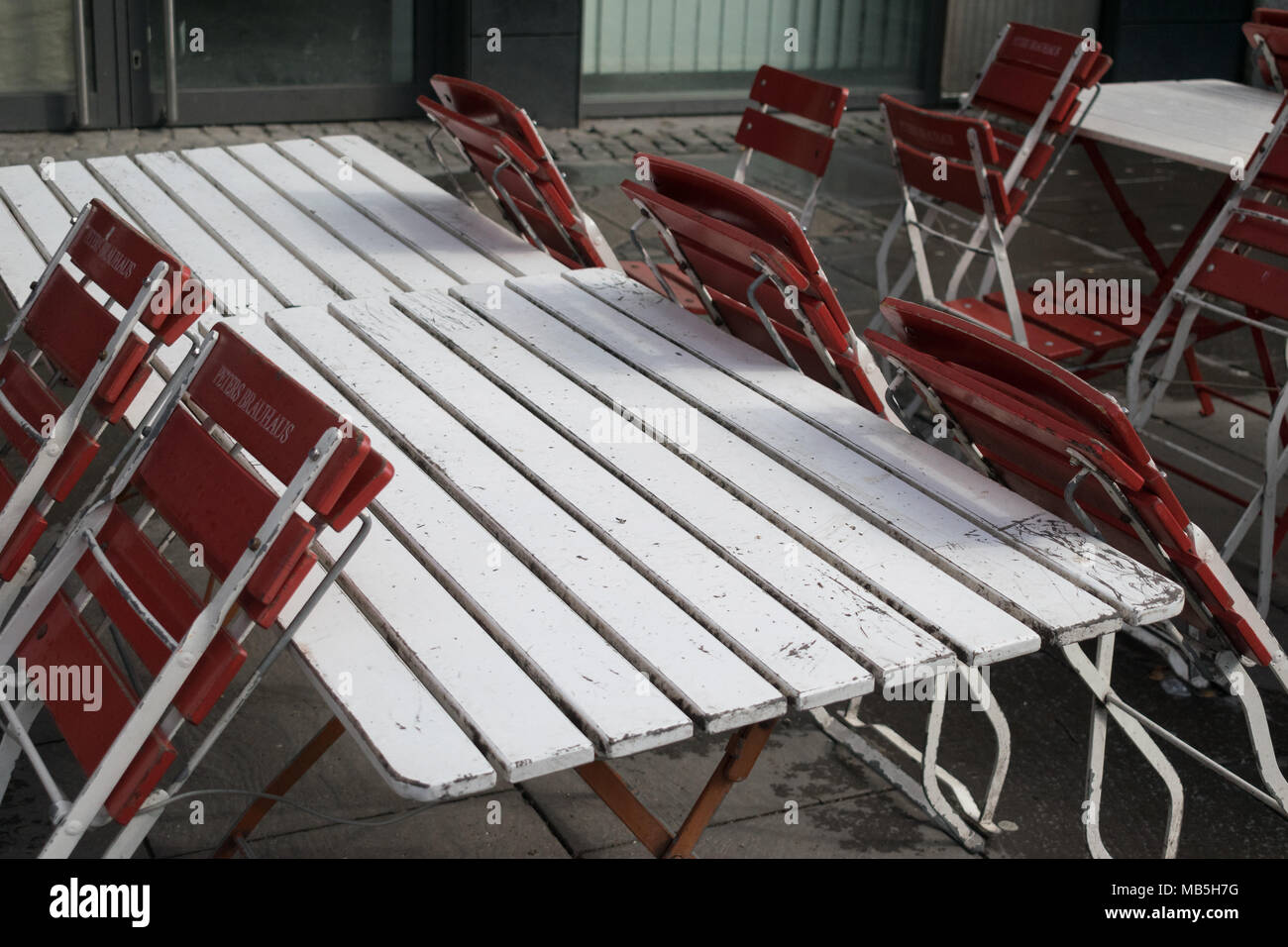 Empty Coffee Terrace Tables Chairs Ajar Wet Wood Spring Wall Off Season. Stock Photo