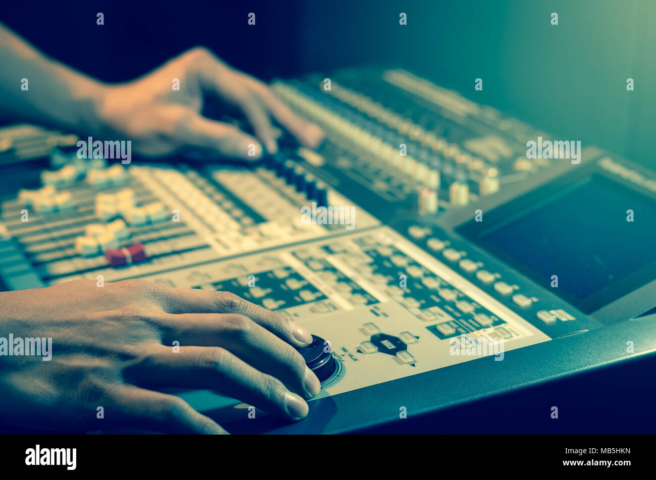 Hand adjusting audio mixer Stock Photo Alamy