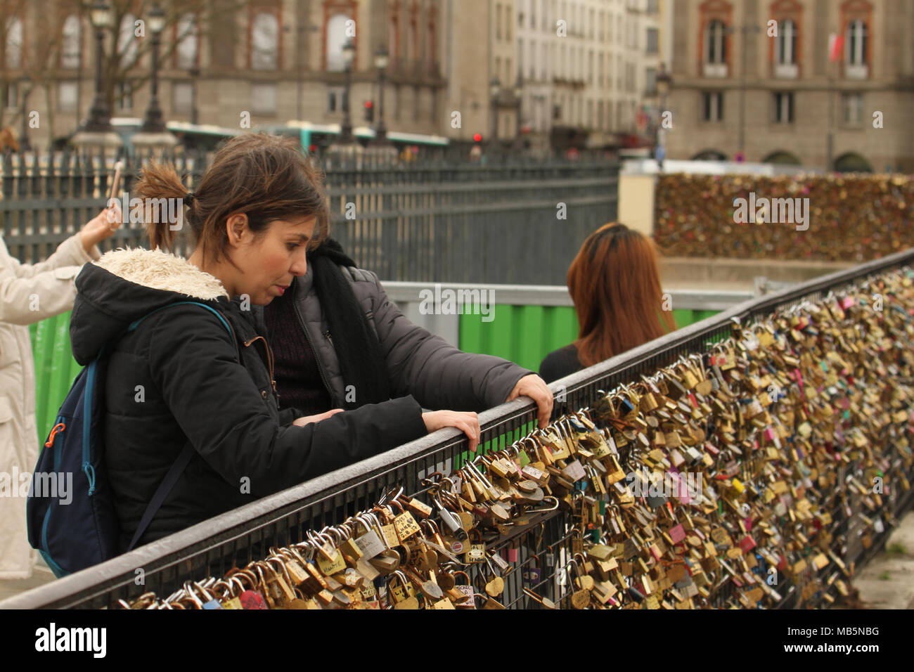Paris, France -  03 April 2018. People admire a bridge covered in padlocks on the bridge at Pont Neuf on 03 April 2018. The first Iron bridge built in France, had its railings replaced with glass panels after they collapsed under the weight on the metal padlocks and this culture has cropped up in other bridges in Paris. General view of Paris, France. @ David Mbiyu/Alamy Live News Stock Photo