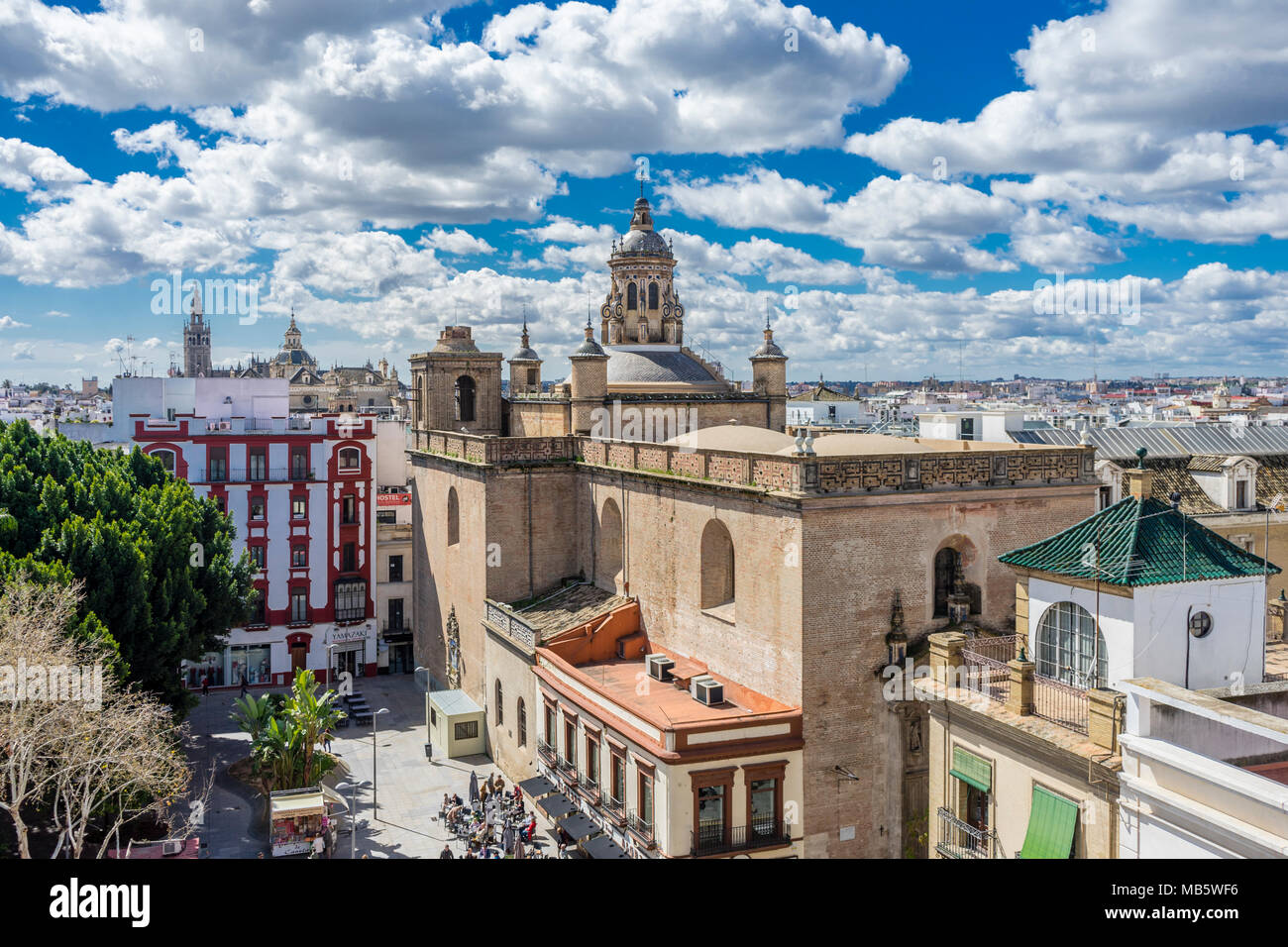 Cityscape view with Iglesia de la Anunciación (Annunciation Church) and the Seville cathedral Giralda bell tower, March 2018, Seville, Stock Photo