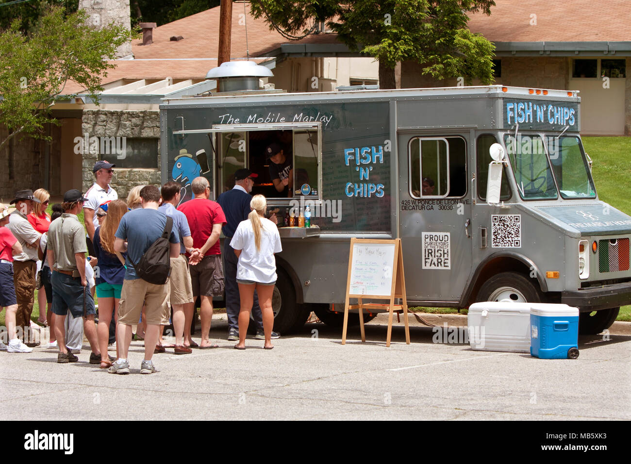 Patrons Stand In Line To Buy Meals From A Fish And Chips