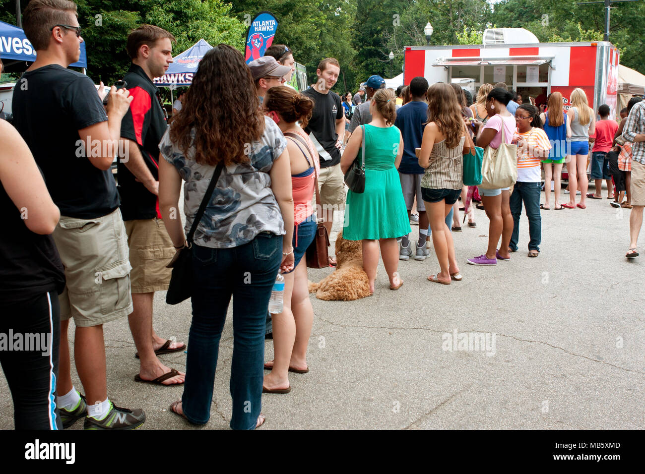A crowd of people wait in line to buy ice cream at the 3rd Annual