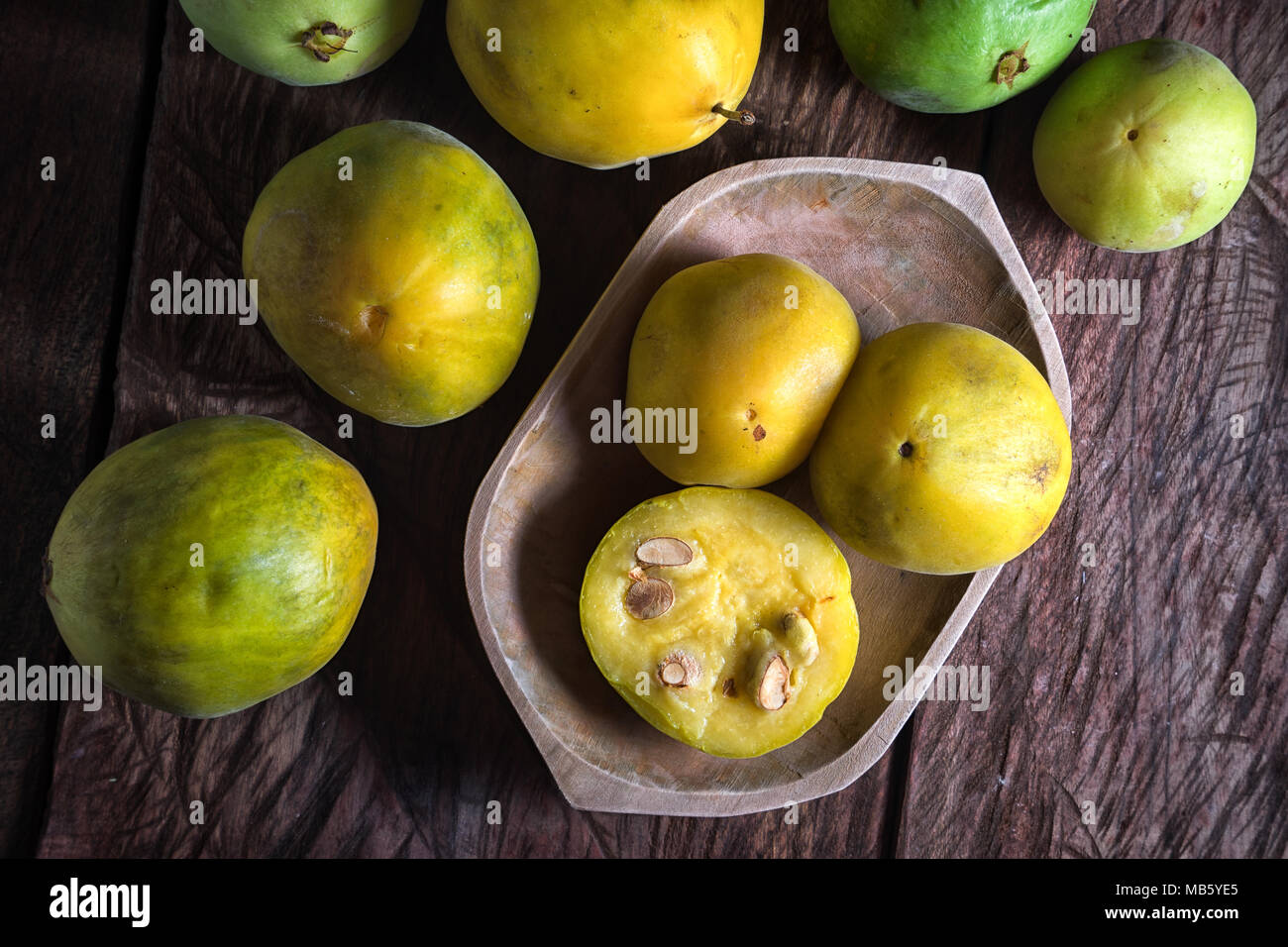 rare araza fruits in a wooden bowl on rustic background Stock Photo