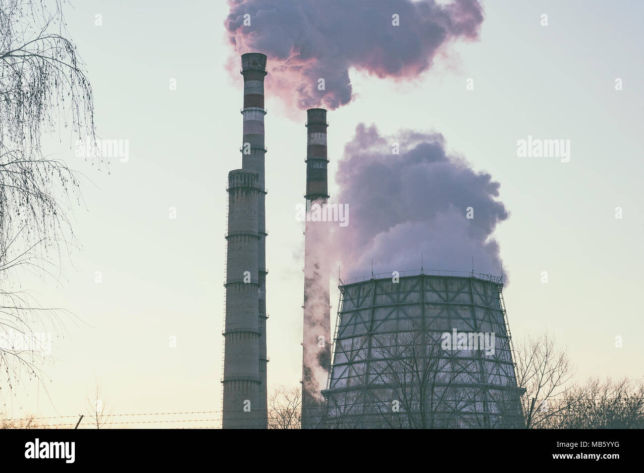 Smoke from factory pipes against the sky. Environmental pollution Stock Photo