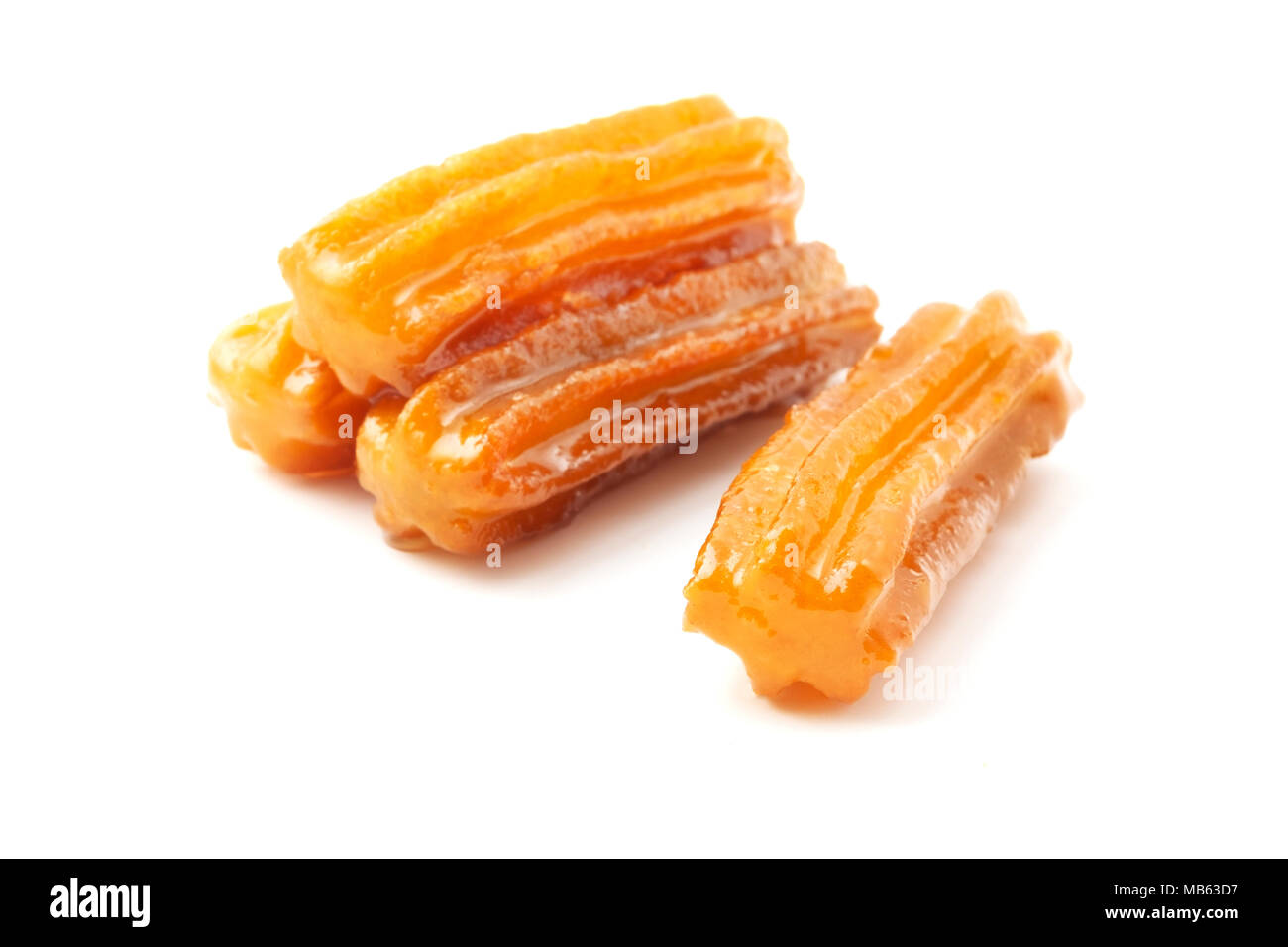 Tulumba (or Bamiyeh), a popular dessert found in the cuisines of the former Ottoman Empire, on a white background Stock Photo