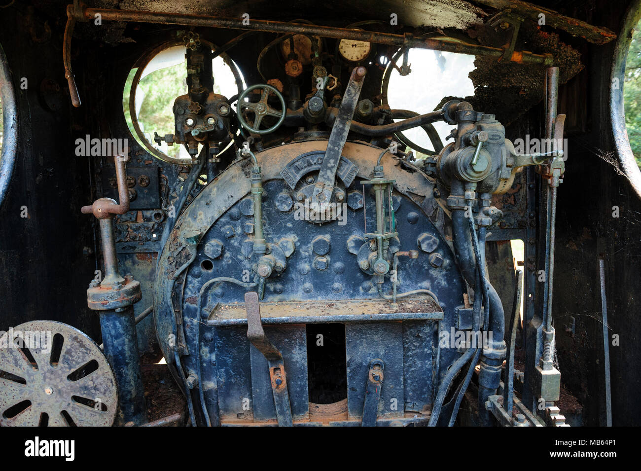 Steam locomotive cab controls and firebox of State Saw Mills steam engine SSM No. 2, slowly rusting away in a rail museum in Pemberton, Western Austra Stock Photo