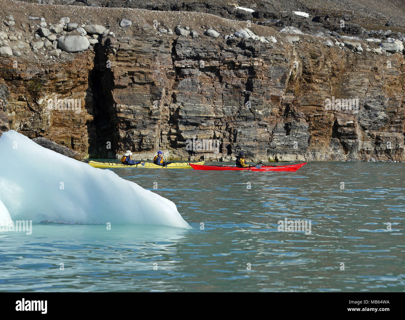Kayaking in the arctic waters of Spitsbergen on the Svalbard Archipelago in the far north of Norway. Stock Photo
