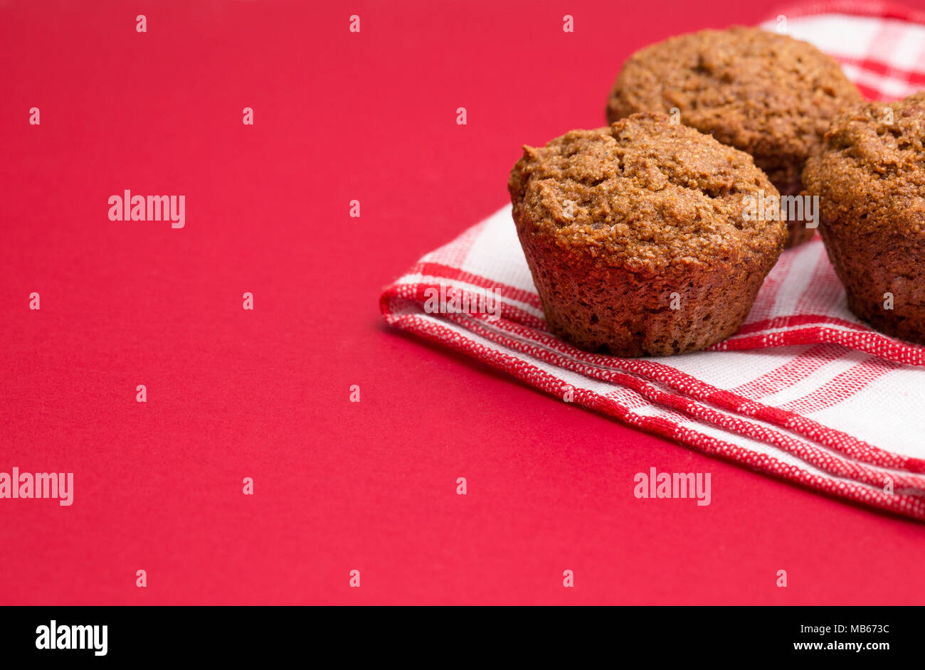 Apple Cinnamon Pecan Muffins on an Apple Red Background Stock Photo