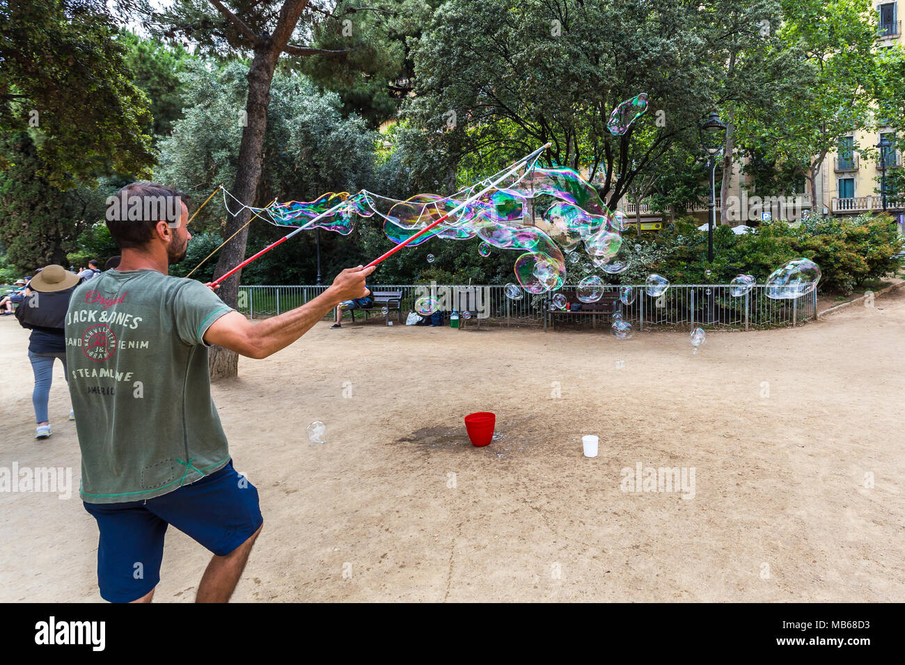 BARCELONA, SPAIN, July 6, 2017: Street artists make soap bubbles in the Plaza de Gaudi for the enjoyment of children and tourists Stock Photo