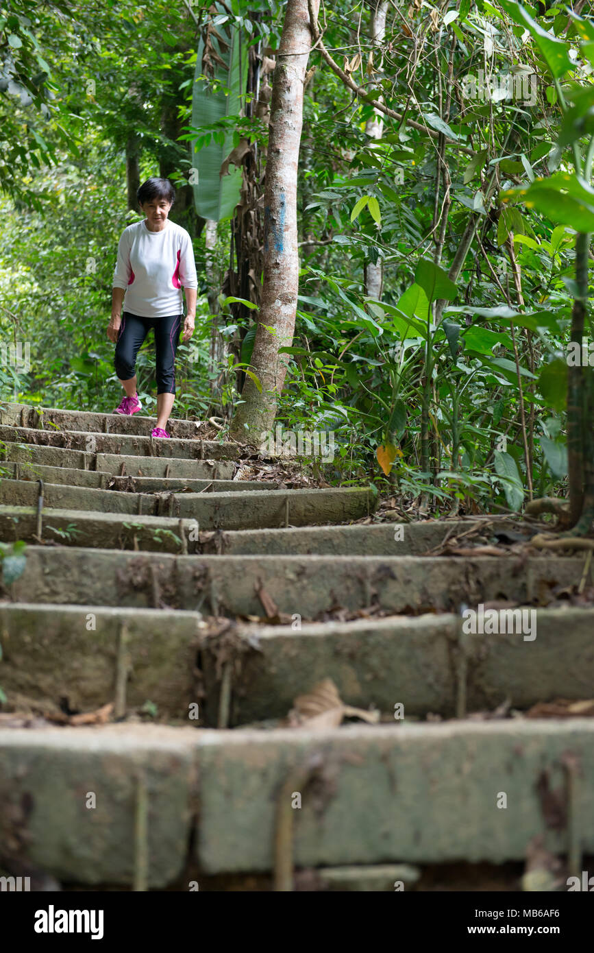 Asian woman hiking in jungle Stock Photo - Alamy