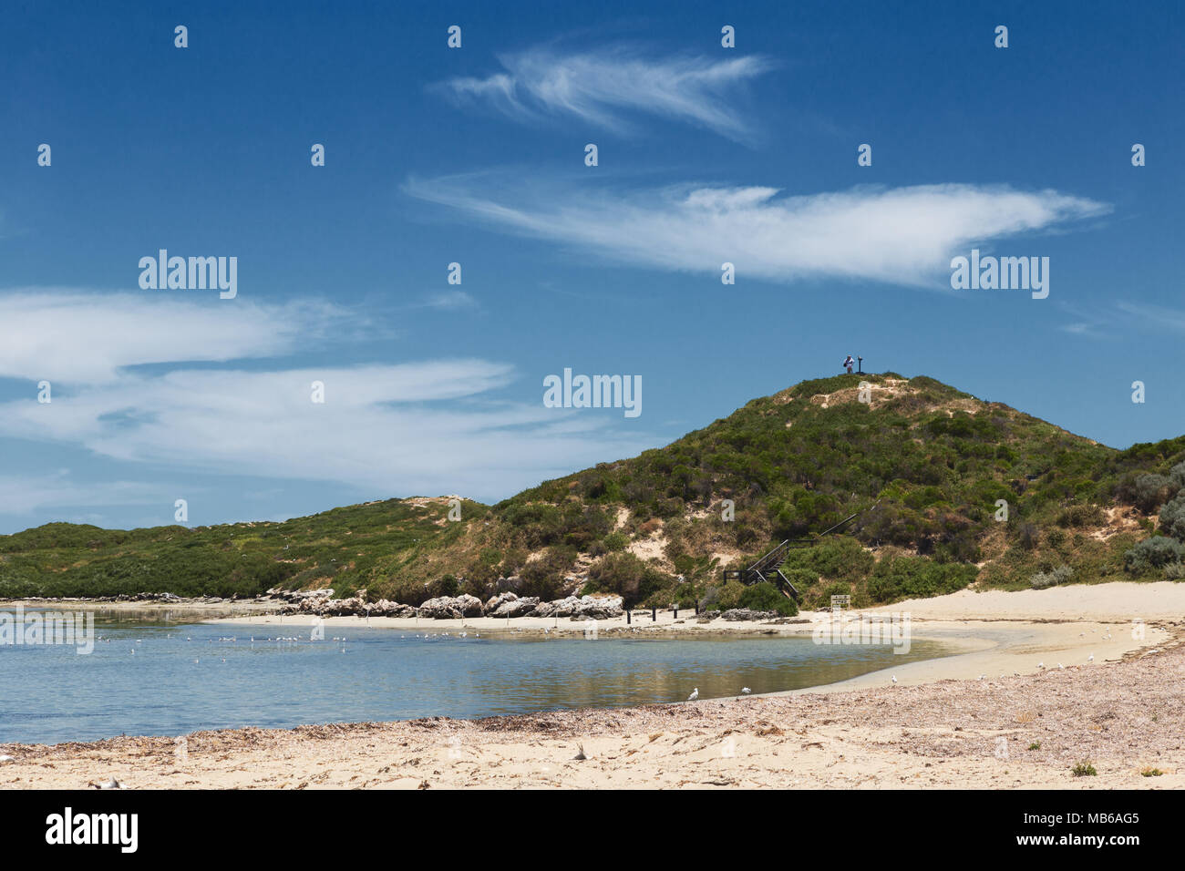 Wisps of cloud against a clear blue sky above Penguin Island, Rockingham, Western Australia Stock Photo